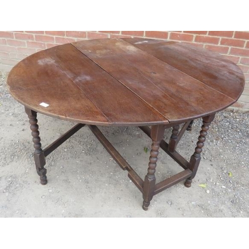 786 - A 19th century oak oval gate-leg table, on bobbin turned supports with stretchers. 
H72cm W148cm D12... 