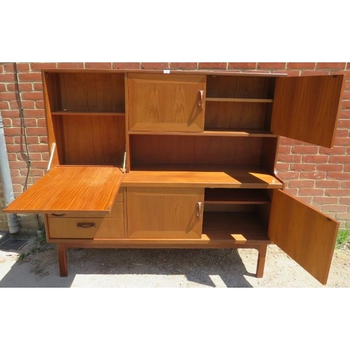 790 - A mid-century afromosia teak crossbanded highboard by G Plan, housing a fall-front cupboard and a fu... 