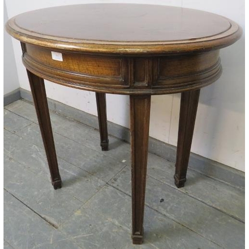 791 - An Edwardian mahogany oval occasional table, with inset burgundy leather surface and fielded frieze ... 