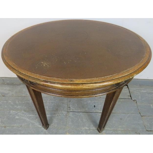 791 - An Edwardian mahogany oval occasional table, with inset burgundy leather surface and fielded frieze ... 