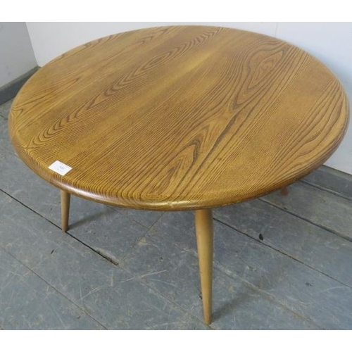 800 - A mid-century blonde elm and beech circular coffee table by Ercol (model 142) on tapering canted sup... 