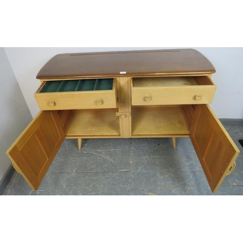 801 - A mid-century elm and beech sideboard by Ercol, housing two short drawers over cupboards with panell... 