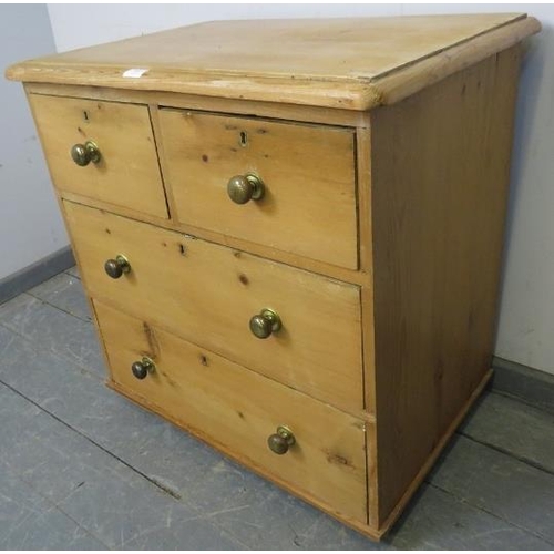 805 - A small antique pine chest of two short over two long drawers with brass knob handles, on block feet... 