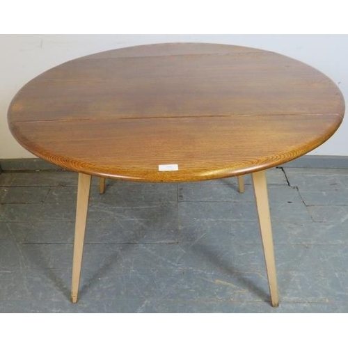 808 - A mid-century elm and beech circular drop-leaf Windsor dining table by Ercol, on tapering canted sup... 