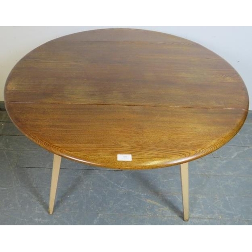 808 - A mid-century elm and beech circular drop-leaf Windsor dining table by Ercol, on tapering canted sup... 