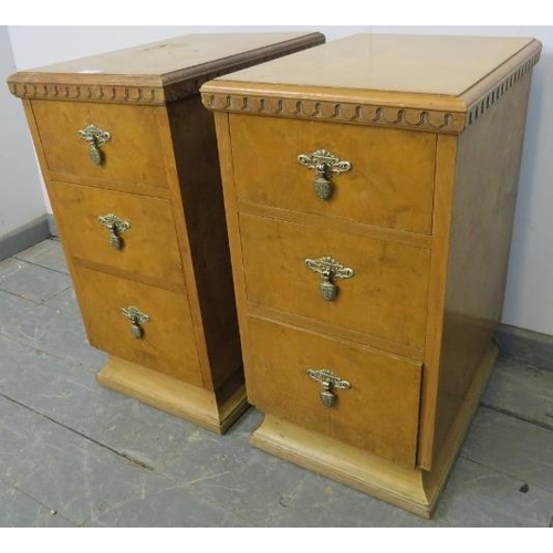 813 - A pair of Art Deco walnut bedside chests, each having three graduated drawers with cast metal handle... 