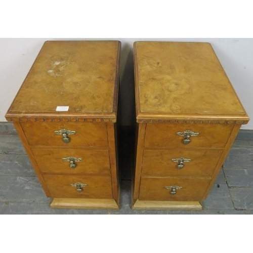 813 - A pair of Art Deco walnut bedside chests, each having three graduated drawers with cast metal handle... 