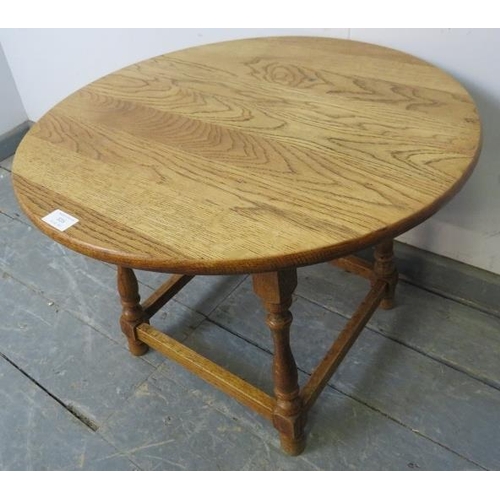 816 - A vintage light oak circular occasional table in the 18th century taste, on baluster turned supports... 