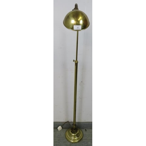 823 - A vintage brass height adjustable floor-standing reading light with goose neck, on a circular plinth... 