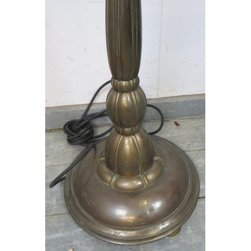 824 - A vintage bronzed height adjustable standard lamp in the Art Nouveau taste, on a circular plinth bas... 