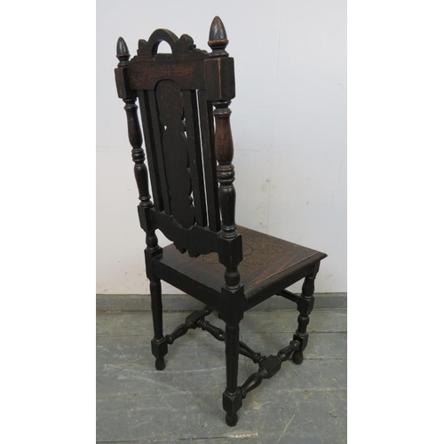 840 - A 19th century oak hall chair, the carved back splat depicting fruiting vines, on 
turned and block ... 