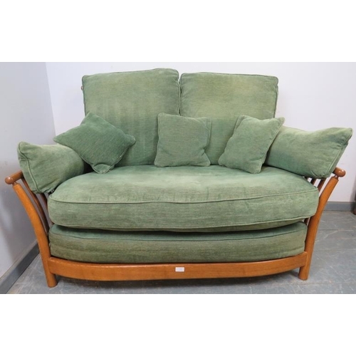 841 - A contemporary ash two-seater sofa by Ercol, with loose cushions in green and matching scatter cushi... 