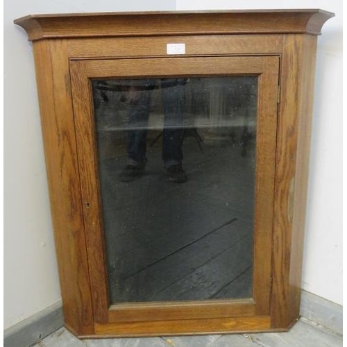 843 - A turn of the century medium oak wall-hanging glazed corner cupboard, with two loose shelves. 
H79cm... 