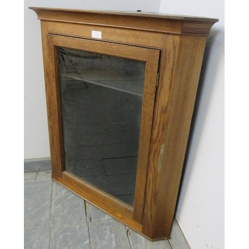 843 - A turn of the century medium oak wall-hanging glazed corner cupboard, with two loose shelves. 
H79cm... 