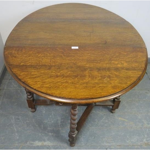 849 - A 19th century oak oval gate leg table on barley twist supports with stretchers. 
H73cm W91cm D42-11... 