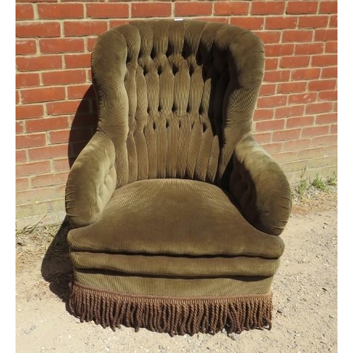 856 - A vintage armchair with sprung base, upholstered in green buttoned corduroy material, on castors. 
H... 