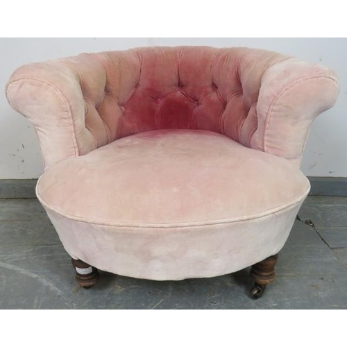 867 - A turn of the century low bedroom tub chair, upholstered in antique buttoned velvet, on turned taper... 