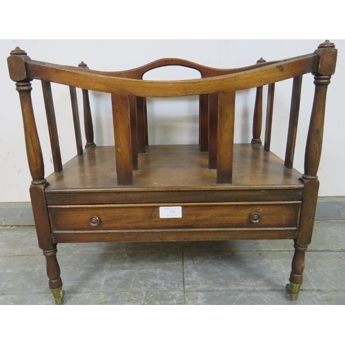 874 - An Edwardian mahogany Canterbury, the turned uprights enclosing divided magazine compartments, above... 