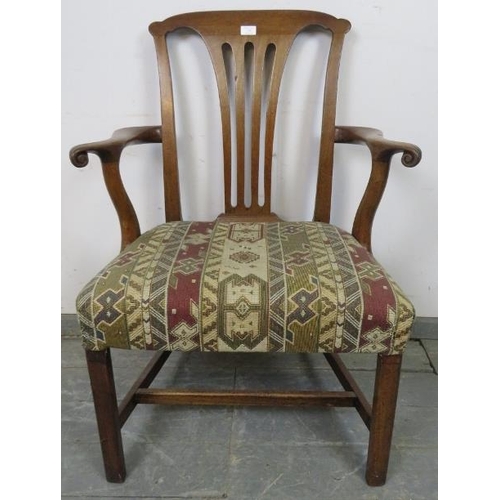 877 - A Georgian mahogany open-sided armchair with scrolled arms, re-upholstered in geometric patterned ta... 