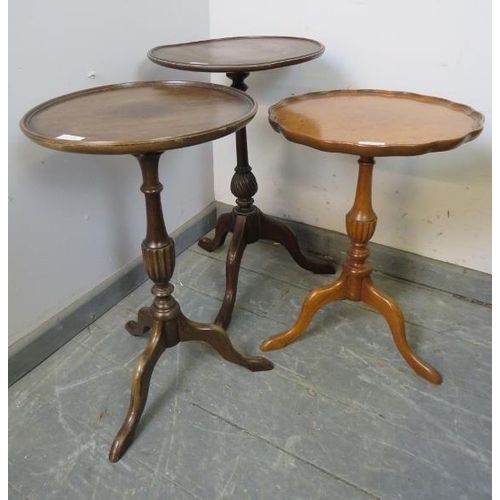 883 - Three vintage wine tables, one mahogany the other in walnut, on tripod bases. 
Largest H51cm Diamete... 