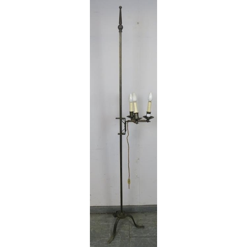 886 - A vintage wrought iron height adjustable standard lamp in the Gothic taste, with top finial and thre... 