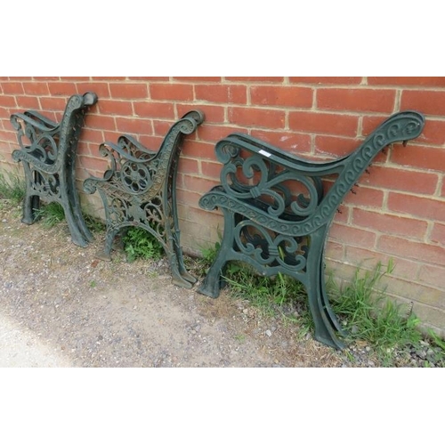 898 - Three pairs of cast iron bench ends painted green, two with scrolled fleur de Lis detail, the other ... 