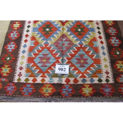 902 - A Chobi Kilim rug. Good strong colours and in very good condition. 158cm x 109cm.