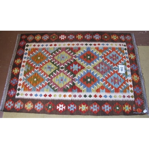 902 - A Chobi Kilim rug. Good strong colours and in very good condition. 158cm x 109cm.