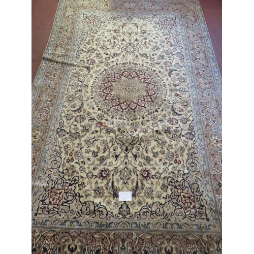 910 - A Fine Persian Naim carpet, a central spirograph pattern on good ground with heavy foliage design. 3... 