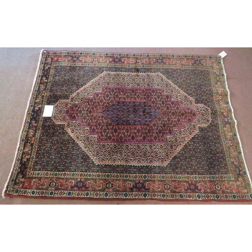 912 - A North West Persian Senneh rug central 3 level motif on a repeat pattern ground. In good condition.... 