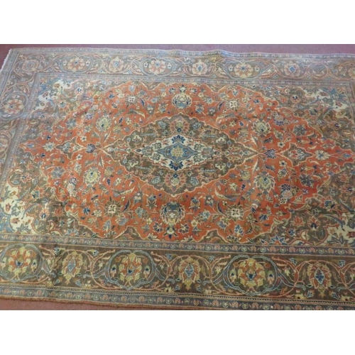 916 - A signed Persian Kashan carpet with central motif on burnt amber field. In good condition. 225cm x 1... 