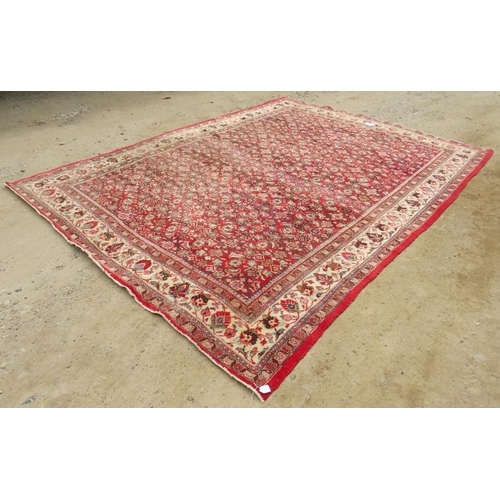 918 - A fine mid 20th century Persian carpet central block pattern on red ground with flowered cream borde... 