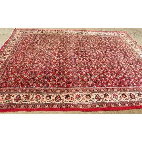 918 - A fine mid 20th century Persian carpet central block pattern on red ground with flowered cream borde... 