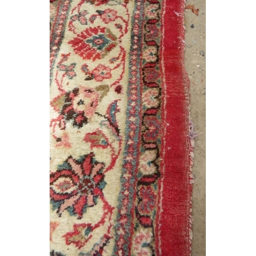 918 - A fine mid 20th century Persian carpet central block pattern on red ground with flowered cream borde... 