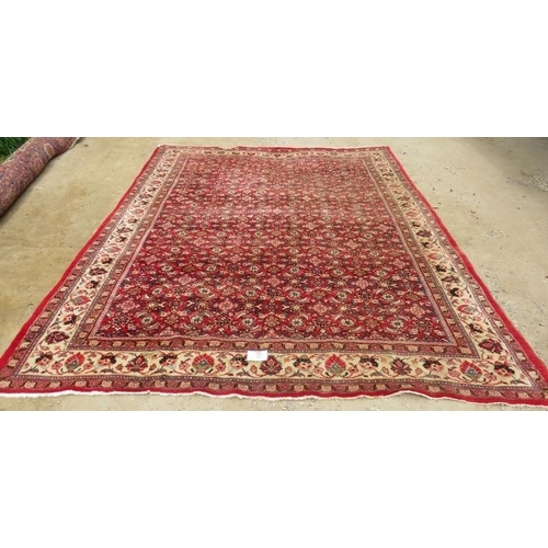 918 - A fine mid 20th century Persian carpet central block pattern on red ground with flowered cream borde... 