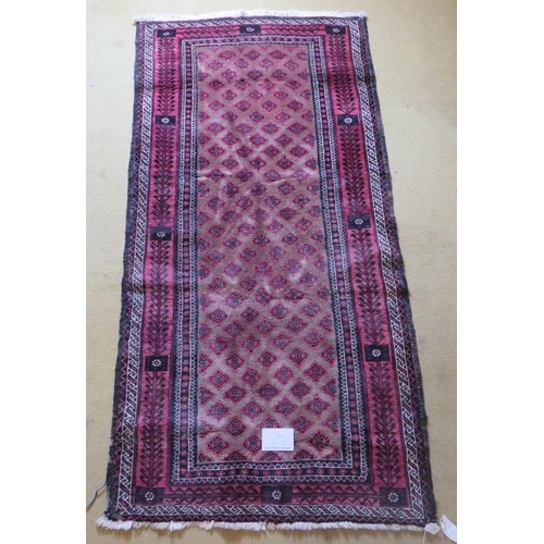 923 - A mid 20th century meshed Baluch rug with rare overall pattern on mellow camel field and abstract tr... 