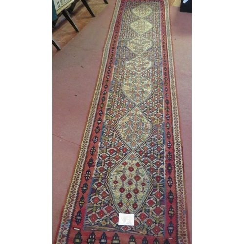 930 - A good North West Persian Senneh Kilim runner, 7 central panels on a patterned ground and in good co... 