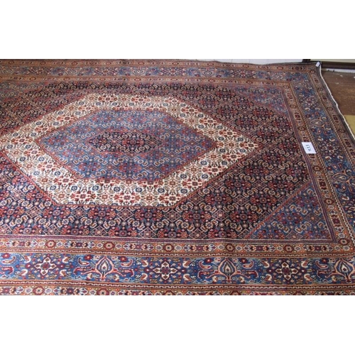 933 - A fine Persian Tabriz carpet, central hexagonal motif on blue ground and in good condition. 390cm x ... 