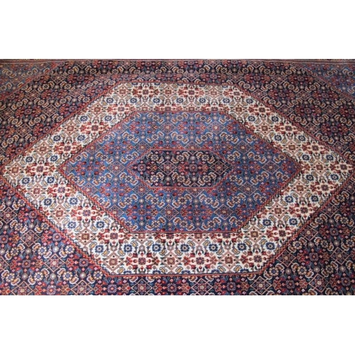 933 - A fine Persian Tabriz carpet, central hexagonal motif on blue ground and in good condition. 390cm x ... 