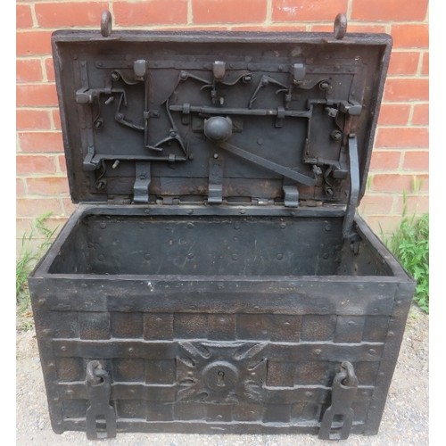 720A - A late 17th/early 18th century Armada chest, of cast iron strapwork construction, the lid with 7-poi... 