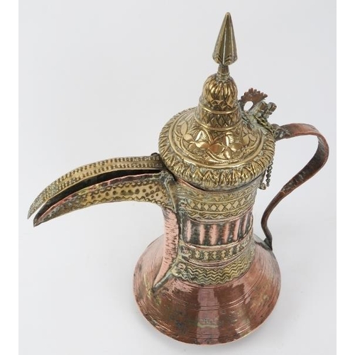 100 - A Middle Eastern copper and brass Dallah, 19th century or earlier. Embossed with a variety of decora... 