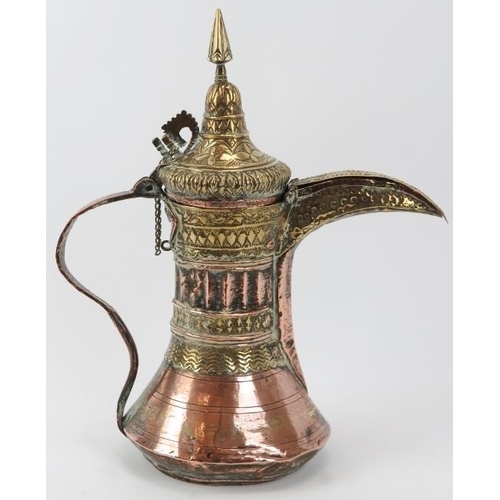 100 - A Middle Eastern copper and brass Dallah, 19th century or earlier. Embossed with a variety of decora... 