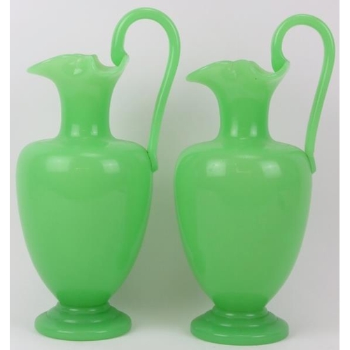 110 - A matched pair of green opaline glass ewers, 19th century. Probably either French or Bohemian. Both ... 