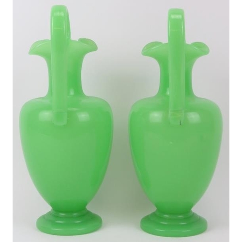 110 - A matched pair of green opaline glass ewers, 19th century. Probably either French or Bohemian. Both ... 