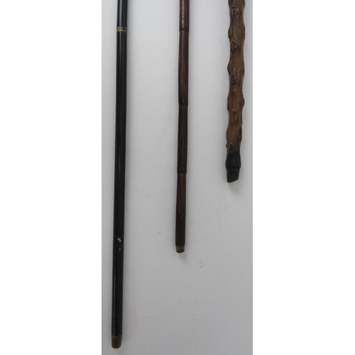 114 - Three Victorian and Edwardian walking canes. Comprising a Victorian crook handled gnarled wood walki... 