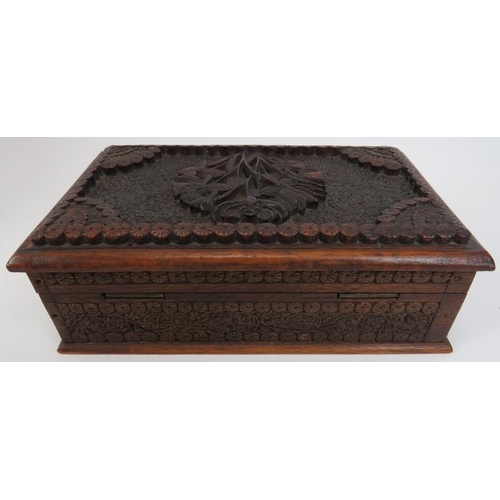 122 - Two Indian carved wood objects,  20th century. Comprising an ornately carved box with hidden sliding... 