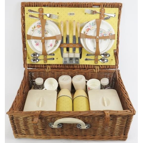 129 - A English vintage Sirram picnic hamper set. Comprising flasks, containers, plates and cutlery housed... 