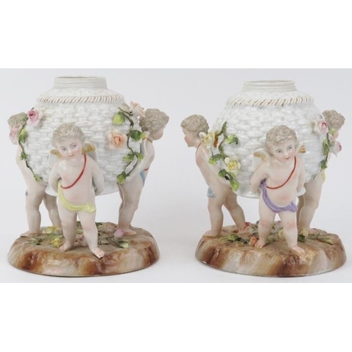 24 - A pair of German Dresden porcelain oil lamp stands. Both modelled depicting three equidistant cherub... 