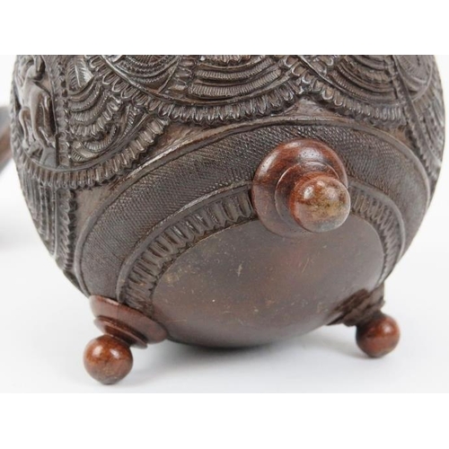 33 - An Anglo Indian carved coconut tea caddy, late 19th/20th century. Carved with bands of decoration an... 