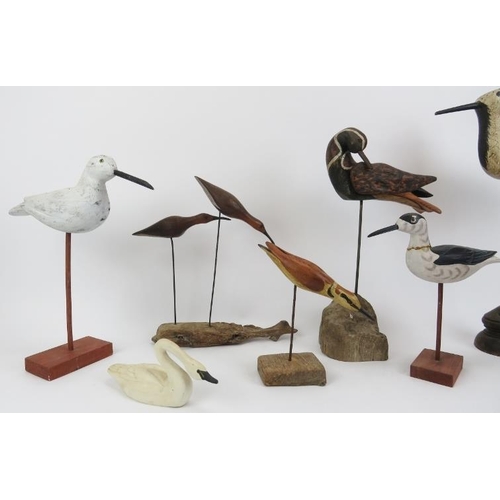 44 - A group of eight hand carved and painted wooden sculptures of birds on stands. (8 items) 46 cm talle... 